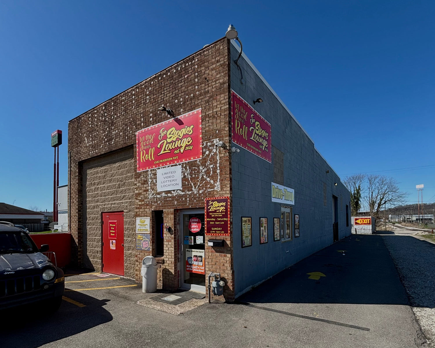 Commercial building with a red sign on a clear day